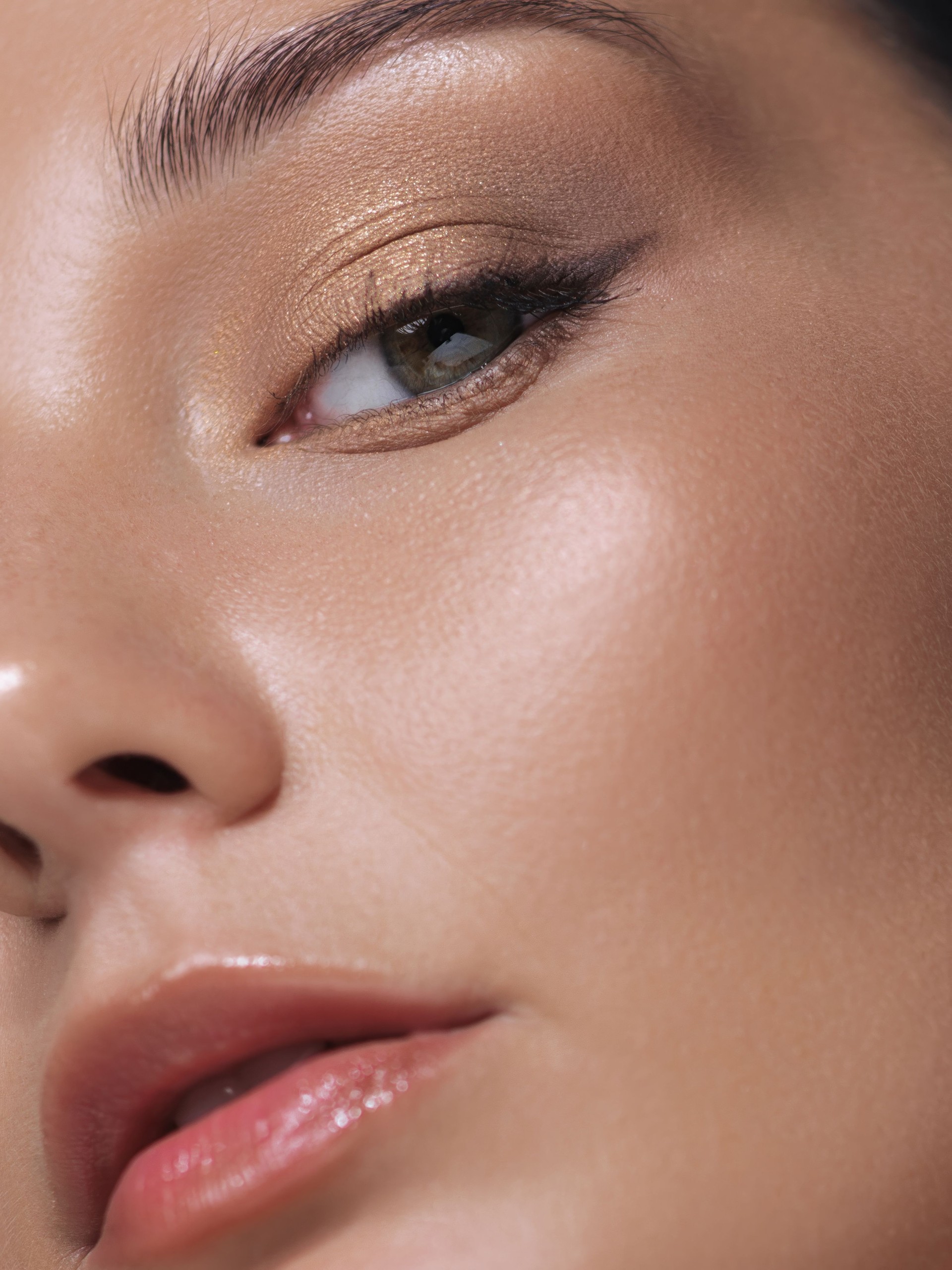 Close-Up of Woman s Face with Golden Eyeshadow and Glossy Lips