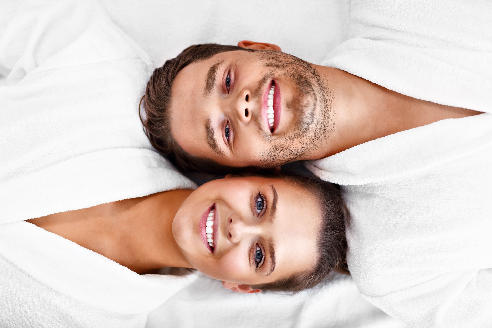 Adult happy couple relaxing in spa salon