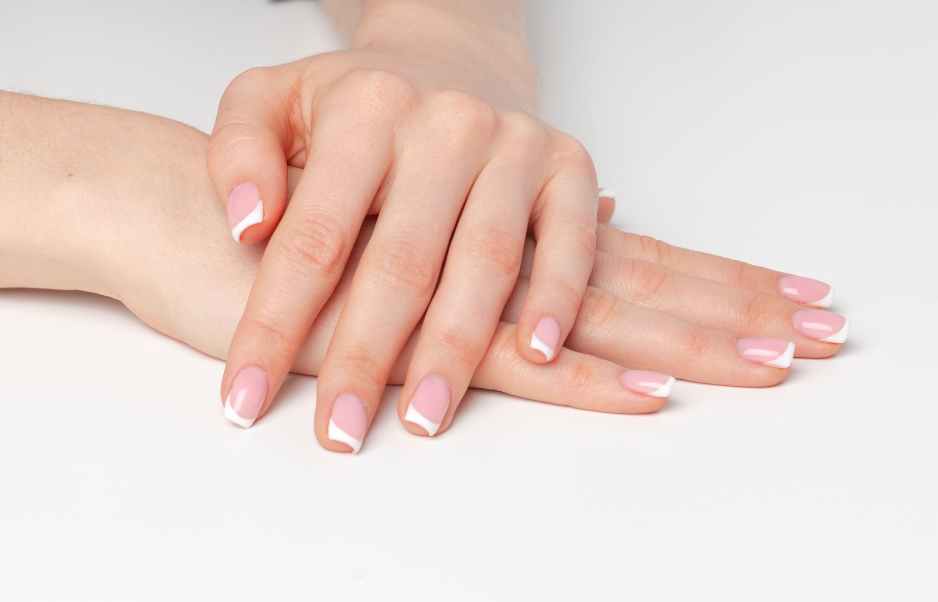 Well-groomed female hands with manicure on white background